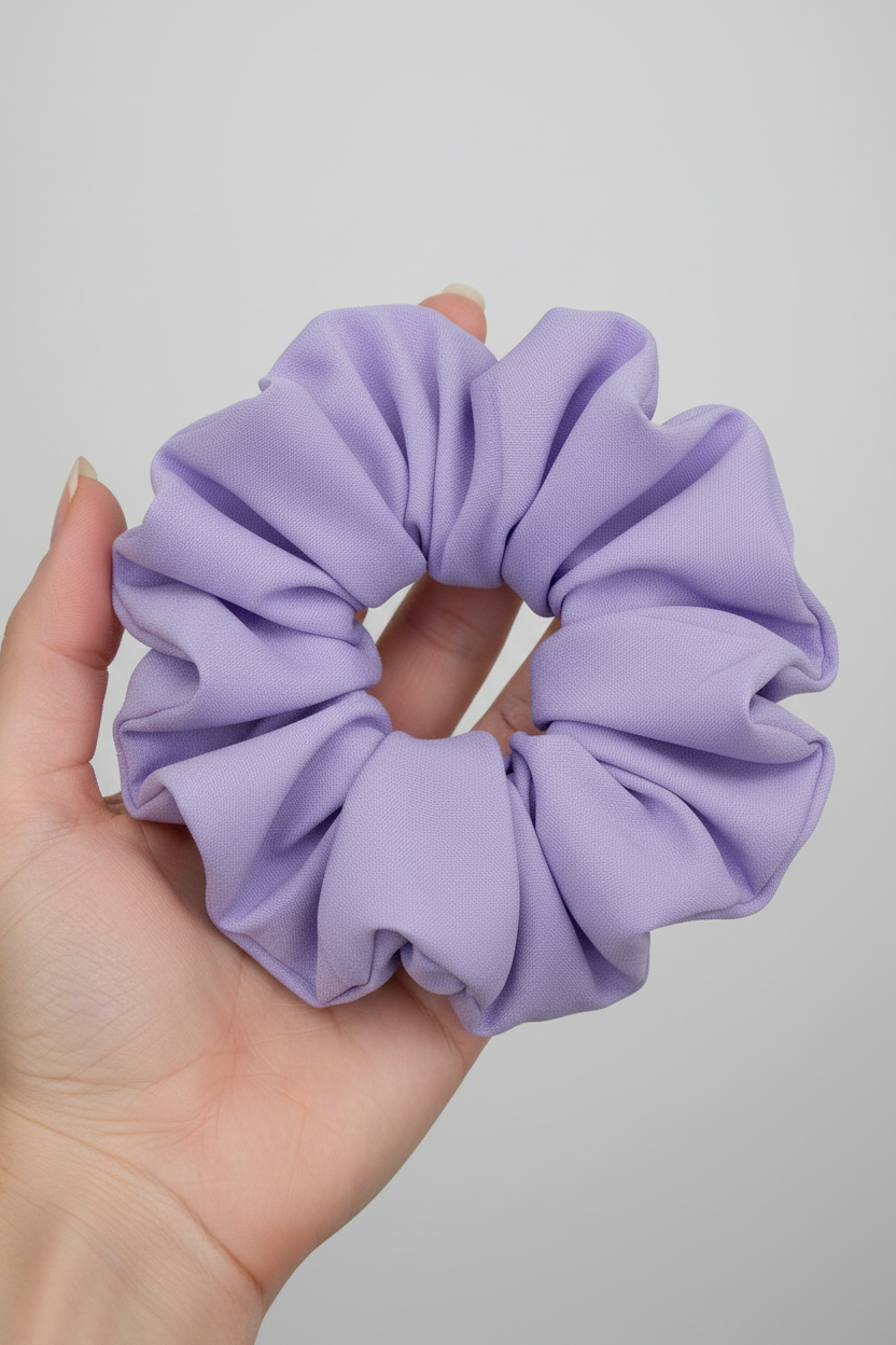 Hand holding lavender purple scrunchie